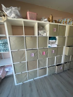 a room that has a bunch of boxes on the shelves
