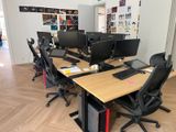 many computers on the desks in this office