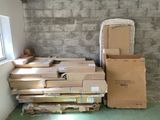 a pile of boxes sitting on the floor next to a window