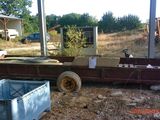 a trailer that is sitting on the ground in the dirt