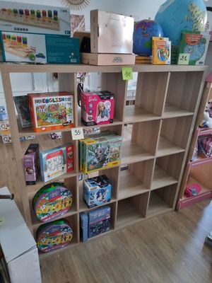 a lot of toys and books on the shelves in the room