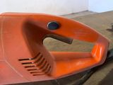 an orange corded blower sitting on a table