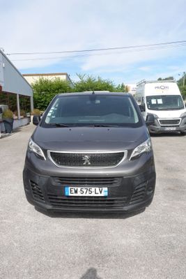 a black van parked in a parking lot next to other vehicles