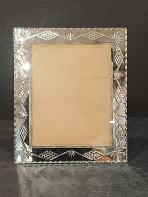 an image of a silver picture frame on a black surface