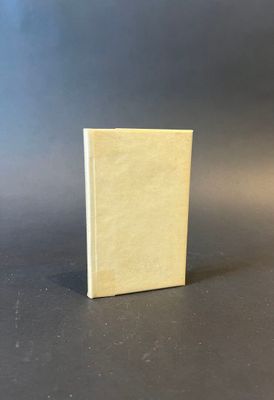 a small book sitting on top of a table next to a black background