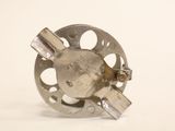 a metal object that is sitting on a white surface
