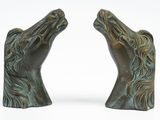 pair of bronze horse head bookends on a white background