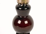 an image of a red and black vase on a white background