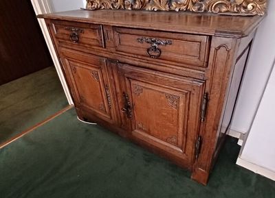 a wooden cabinet with a mirror on top of it