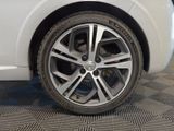 a close up of a tire on a white car