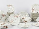 a lot of plates and bowls that are sitting on a table