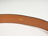 a close up of a brown belt on a white surface