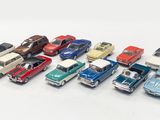 several toy cars are lined up in a row on a white surface