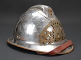 a silver helmet with a red strap on it