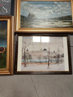 three framed paintings of cows in a field with a building in the background