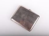 an image of a small silver case sitting on top of a white surface