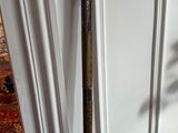 a broom that is sitting on the floor in front of a door