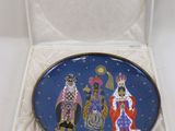a blue plate with a picture of three wise men and a star in the sky