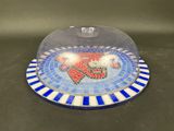 a close up of a plate with a glass dome on it