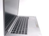 a silver laptop computer sitting on top of a white table