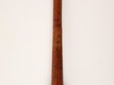 an old wooden baseball bat hanging on a wall