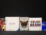 four books that are sitting next to each other on a table