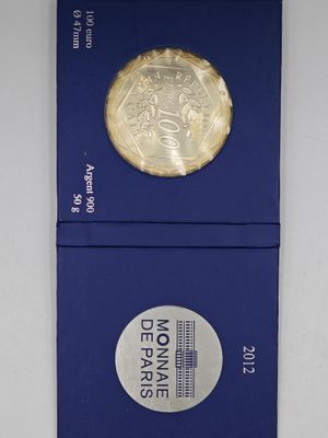 a close up of a blue box with a gold coin on it