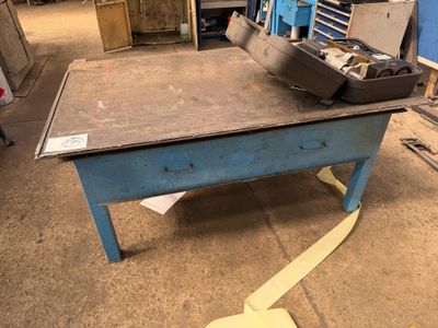 a blue table with a metal bowl on it
