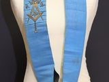 a close up of a mannequin with a blue sash on it