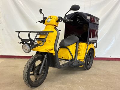 an image of a yellow scooter parked in a garage
