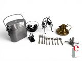 a lot of silverware on a white table