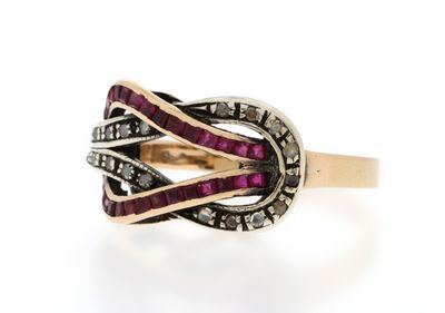 a close up of a ring with a red stone in it
