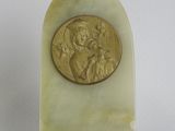 a gold coin sitting on top of a piece of marble