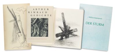 several books are lined up on top of each other on a white surface
