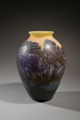 a vase with a painting on it sitting on a table