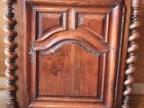 a wooden cabinet with a mirror on top of it