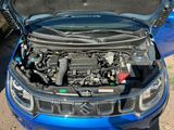 a blue truck with the hood open and the engine in the back