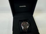 a black watch in a black box on a white table