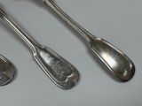 three spoons and two spoon spoons on a table