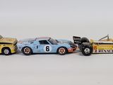 three toy cars sitting next to each other on a white surface