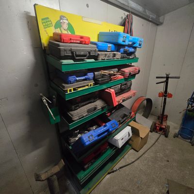 a lot of tools on the shelves in the garage