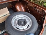 a trunk of a car with a tire and a box in the trunk