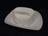 a white cowboy hat sitting on top of a white plate