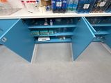 a blue cabinet with a lot of bottles of water on it