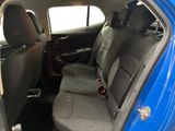the back seats of a blue car with a black seat belt