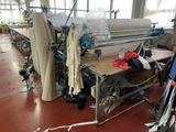 a machine that is working on fabric in a factory
