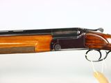 a close up of a shotgun with a wooden handle on a white background