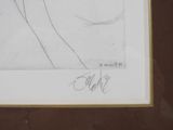 drawing of a woman ' s face in profile with her hair pulled back