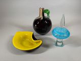 three glass objects that are sitting on a table