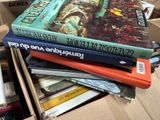 many books stacked on top of each other in a box